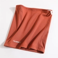Detail view of winter neck gaiter featuring adjustable drawstring and soft fleece texture - Orange