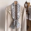 Elegant black and white paisley silk scarf tied on a beige suit as a decorative accessory - Black and White Paisley Classic (LJ21-H276) / 145x12cm