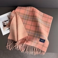 Detail of pink and brown plaid scarf featuring long tassels and double-sided patterns - Pink