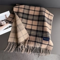 Detailed texture of British style plaid scarf with soft fringe and dual pattern design - Tan