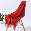 Vibrant red cashmere feel scarf with fringe tassel detail on white chair - Brick Red (FYR150-03)