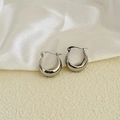 Detail van zilverkleurige grove U-vormige oorbellen met hoogglans afwerking en een kliksluiting - Zilver (B111)
