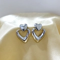 Polished silver double heart drop earrings displayed on elegant champagne silk fabric - Silver Heart