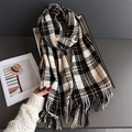 Detailed close-up of thick plaid cashmere feel scarf with fringe tassels in brown and black - Black