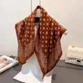 Caramel cashew pattern silk scarf with elegant mandala print on a mannequin display - Brown