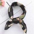 Elegant black satin square scarf featuring colorful feather patterns tied in a chic loop - Feather Black (FX-8)