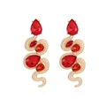 Retro golden snake earrings with vibrant red pear-shaped gemstones on white background - Red