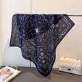 Elegant navy paisley cotton linen scarf displayed on a silver metal rack with a white bag - Navy Blue