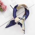 Elegant navy blue silk scarf with yellow abstract waves shown in a stylish knot - Graffiti Block Navy (FX-28)