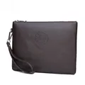 Detail of dark brown pebble leather clutch bag with silver zipper and embossed logo - Litchi Pattern Style 2 / Brown (Litchi Pattern)