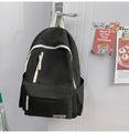 Close-up of black and white contrast nylon backpack hanging on a door with side pockets - Single Bag / Black
