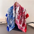 Detail of silk-like floral square scarf draped on a hanger with artistic prints - 90x90cm / Red Blue Floral