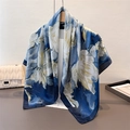 Dettaglio di una sciarpa in seta a fiori blu e oro appesa a una gruccia in legno - 90*90cm / Floreale Blu Profondo (FM298-2)