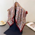 Detail of elegant paisley patterned scarf draped on a wooden hanger over black clothing - 68*68cm / Red