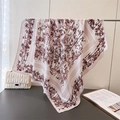 Detail of silk scarf with bamboo ink print and pink striped border on metal rack - 90x90cm / Pink