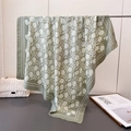 Dettaglio di elegante foulard in seta verde con stampe floreali bianche e trama in twill - Verde