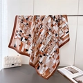 Geometric floral faux silk square scarf draped on a stand with a modern aesthetic - Brown