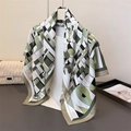 Detail of silk-like scarf featuring green geometric patterns and abstract floral print - Green