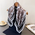 Close-up of paisley silk scarf styled with a navy garment and elegant lifestyle props - One Size (66-70cm) / Black (FG88-4)