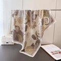 Detailed close-up of large silk-like square scarf with elegant vintage floral print - Beige