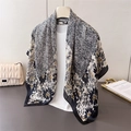Elegant black and white floral silk scarf displayed on a hanger with modern styling - 90cmx90cm / Black