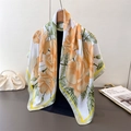 Detailed view of yellow and orange rose patterns on a white silk scarf with green borders - 90x90cm / Green