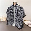 Detail of silk-like scarf with asymmetrical paisley and polka dot print on a hanger - 90*90cm / Black