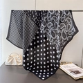 Elegant black and white paisley silk scarf with dots hanging on a metal rack - 90*90cm / Black