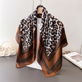 Detail of silk-like leopard print square scarf draped elegantly on a wooden hanger - 90*90cm / Brown(FM265-2)