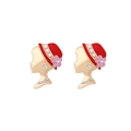 Vintage gold-toned earrings with red enamel lady profile and pearl accents on white background - Red