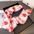 Pink and white silk scarf with pomegranate print elegantly styled on a tray - Pink (Pomegranate Print)