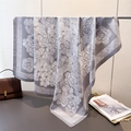 Detail of silk-like square scarf with white camellia print and soft glossy drape finish - Gray