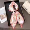 Elegant peach print double-layered silk scarf tied in a bow on a black tray with bag - Pink Peach Print
