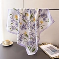 Detail view of purple tulip print silk scarf with smooth texture on a display stand - 70cmx70cm / Purple (Purple Tulip/Purple Border)