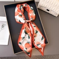 Long silk-like scarf with orange fruit print and red border tied on black tray - 147x14cm / Red Orange Print (LE26-2)