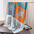 Macro detail of orange and blue paisley silk scarf draped over a grey surface - Orange Patchwork Paisley Style (XD47-4) / Orange