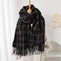Detail of black plaid cashmere scarf featuring soft knit texture and long tassel edges - Black