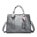 Gray crocodile texture handbag with adjustable shoulder strap and colorful silk scarf detail - Gray