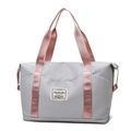 Gray travel bag with pink handles featuring a expandable bottom and waterproof fabric - Grey and Pink