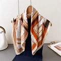 Vintage silk scarf featuring equestrian prints and belt motifs draped on a wooden hanger - 66-70CM / FG62-2 Orange
