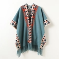 Detail view of ethnic geometric jacquard pattern and long fringes on a blue knit poncho - 168CM / Green