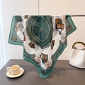 Detail shot of a silk-feel square scarf featuring vintage horse carriage and chain patterns - 68x68cm / Green