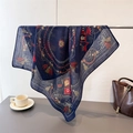 Close-up of navy silk scarf with classic horse carriage pattern and tassels on metal rack - 68x68cm / Navy Blue
