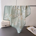 Detailed view of elegant mint green floral silk scarf draped over a metal rod - Green