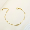 Elegante goudkleurige kralenarmband met fonkelende zirkoon zwaanbedeltje en karabijnslot - Pauw Zwaan Stijl (B0019)
