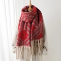Winter plaid scarf in red and beige with decorative tassels shown on a model - Red