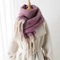 Thick geometric plaid scarf in burgundy and beige with tassels on a mannequin - Pink