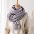 Detail of purple and beige plaid scarf showing soft cashmere-like texture and tassel trim - Lavender