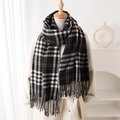 Plaid cashmere-like scarf with fringe tassels shown on a model in a warm home setting - Black (WT204-2)