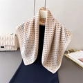 Elegant beige polka dot scarf with silky texture hanging on a hanger in a lifestyle setting - Beige